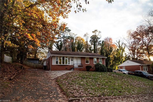 ranch-style home featuring a front yard