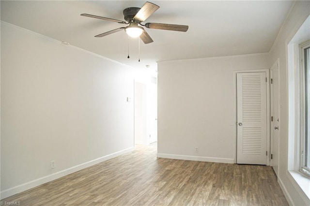 unfurnished room with hardwood / wood-style flooring, ceiling fan, and ornamental molding