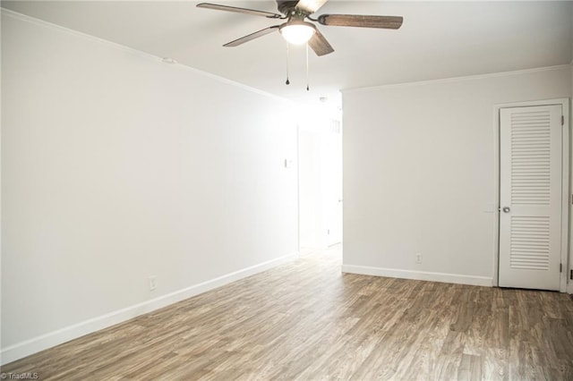 spare room featuring ceiling fan, hardwood / wood-style floors, and ornamental molding