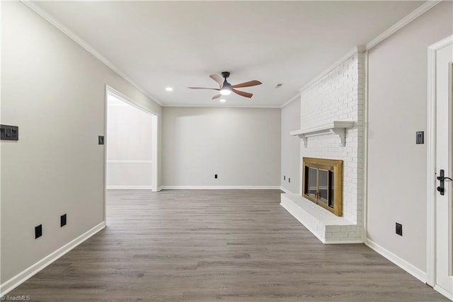 unfurnished living room with a fireplace, ornamental molding, dark hardwood / wood-style flooring, and ceiling fan