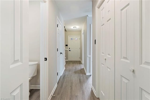 corridor with light hardwood / wood-style flooring