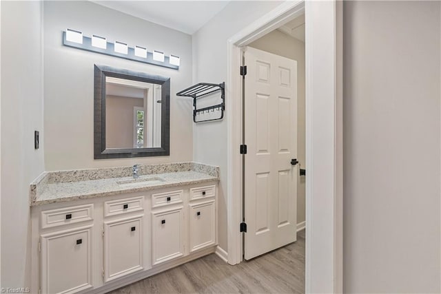 bathroom featuring hardwood / wood-style flooring and vanity