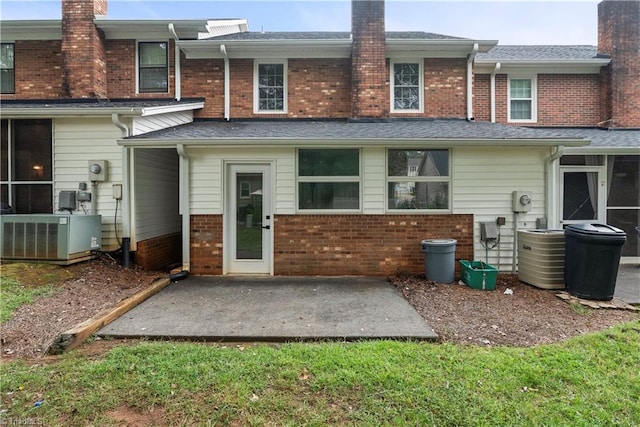 rear view of property featuring central air condition unit and a patio area