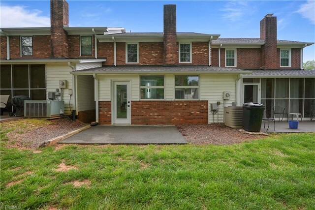 2913 Burke Place Ct, Winston-Salem, NC 27103 - back of property with a chimney, brick siding, a patio, central AC unit, and a sunroom