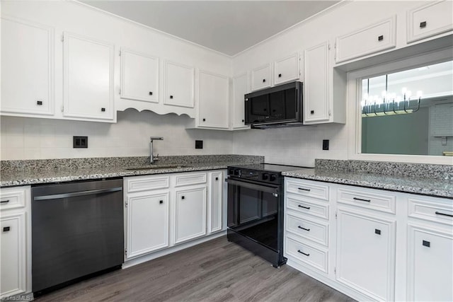 kitchen featuring sink, white cabinetry, black appliances, light stone countertops, and dark hardwood / wood-style flooring