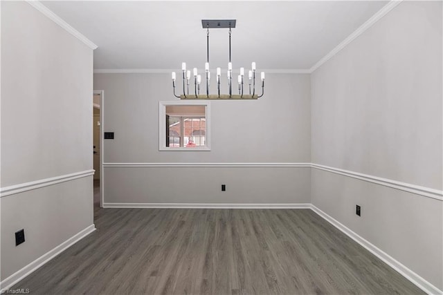 unfurnished dining area featuring crown molding, dark hardwood / wood-style floors, and a chandelier