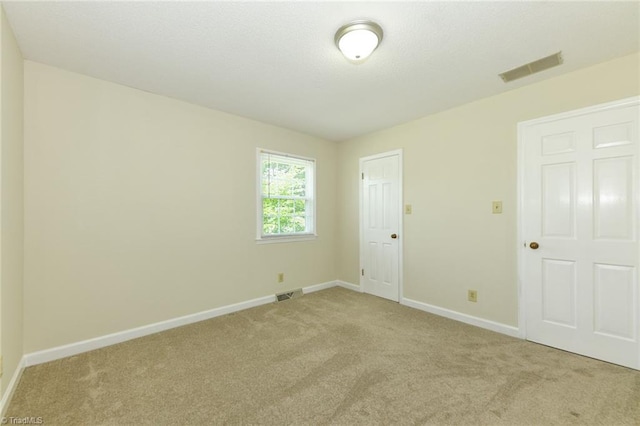 unfurnished bedroom with light carpet and baseboards