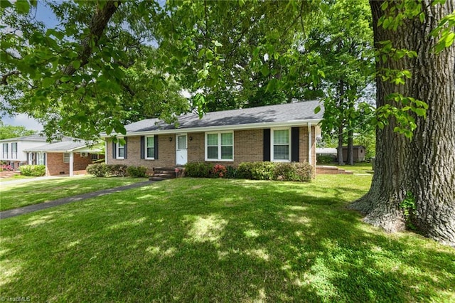 ranch-style house featuring brick siding and a front lawn