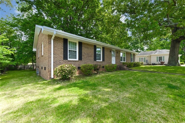 ranch-style home featuring a front lawn, crawl space, and brick siding