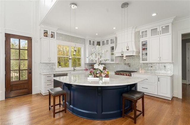 6323 Nesting Way, Oak Ridge, NC 27310 - kitchen featuring appliances with stainless steel finishes, a breakfast bar, white cabinetry, and custom range hood