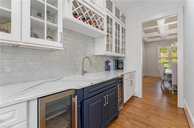 6323 Nesting Way, Oak Ridge, NC 27310 - kitchen featuring crown molding, blue cabinets, beverage cooler, backsplash, and coffered ceiling