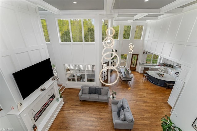 6323 Nesting Way, Oak Ridge, NC 27310 - living area with a decorative wall, ornamental molding, wood finished floors, and beamed ceiling