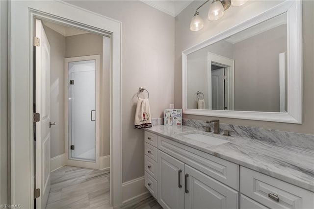 6323 Nesting Way, Oak Ridge, NC 27310 - full bathroom featuring vanity, ornamental molding, baseboards, and a stall shower