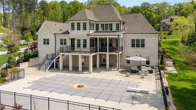 6323 Nesting Way, Oak Ridge, NC 27310 - back of property featuring stairway, fence, a patio area, a wooden deck, and an outdoor living space with a fire pit