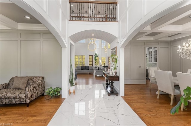 6323 Nesting Way, Oak Ridge, NC 27310 - entryway featuring marble finish floor, arched walkways, a notable chandelier, and a decorative wall