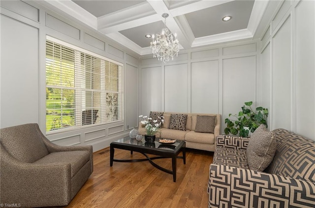 6323 Nesting Way, Oak Ridge, NC 27310 - living room featuring beam ceiling, wood finished floors, an inviting chandelier, and a decorative wall