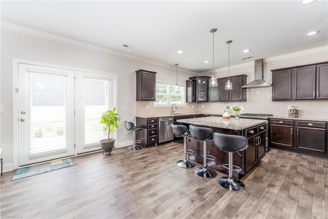 2110 Owls View Ln, Colfax, NC 27235 - kitchen featuring wall chimney exhaust hood, stainless steel appliances, light wood-style flooring, dark brown cabinets, and ornamental molding