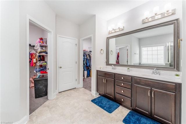 2110 Owls View Ln, Colfax, NC 27235 - bathroom featuring double vanity and a walk in closet