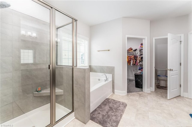 2110 Owls View Ln, Colfax, NC 27235 - bathroom with a bath, a stall shower, and a spacious closet