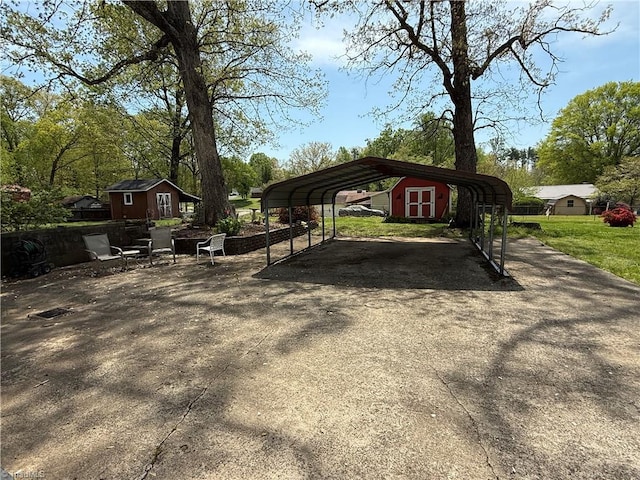 1632 Sanford Dr, Winston-Salem, NC 27105 - view of parking / parking lot with a shed, driveway, and a detached carport
