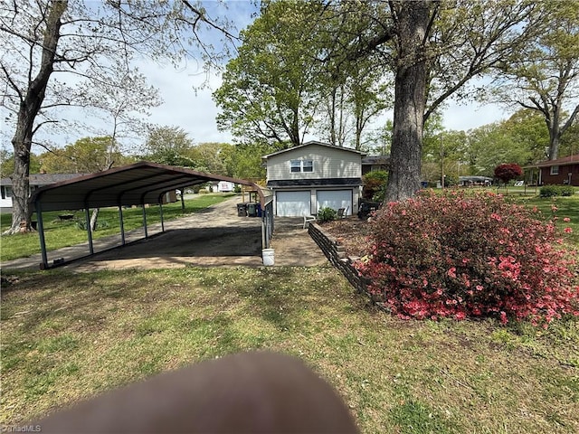 1632 Sanford Dr, Winston-Salem, NC 27105 - view of yard featuring a carport, driveway, and a garage