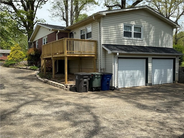 1632 Sanford Dr, Winston-Salem, NC 27105 - view of side of property with an attached garage, driveway, a wooden deck, and stairway