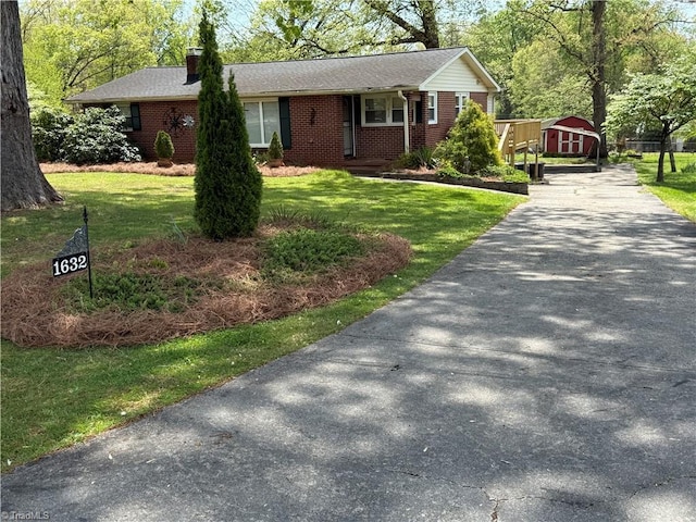 1632 Sanford Dr, Winston-Salem, NC 27105 - ranch-style home featuring brick siding, a front lawn, driveway, and an outbuilding