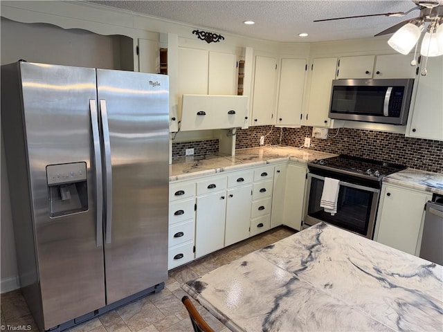1632 Sanford Dr, Winston-Salem, NC 27105 - kitchen with decorative backsplash, a textured ceiling, a ceiling fan, and appliances with stainless steel finishes