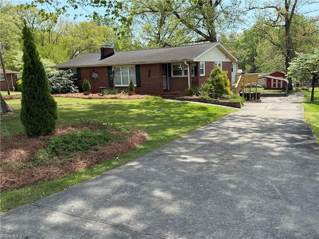 1632 Sanford Dr, Winston-Salem, NC 27105 - single story home featuring a chimney, driveway, a front yard, brick siding, and an outbuilding