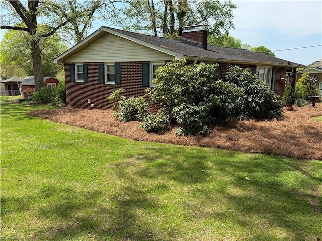 1632 Sanford Dr, Winston-Salem, NC 27105 - view of property exterior with brick siding, a chimney, and a lawn