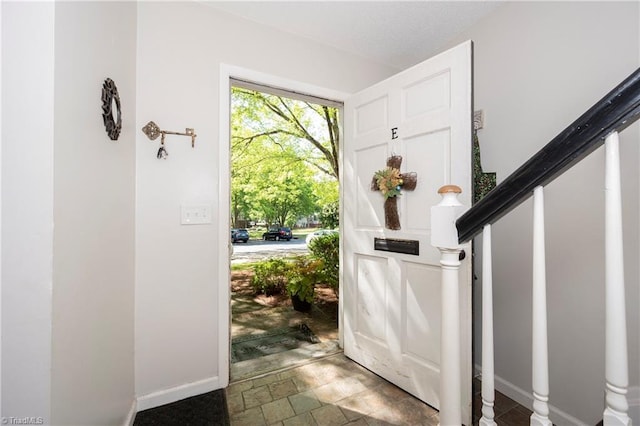 3950 Valley Ct Unit E, Winston-Salem, NC 27106 - foyer entrance featuring stairway, baseboards, and stone finish floors