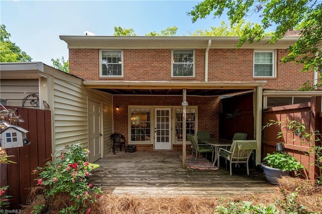 3950 Valley Ct Unit E, Winston-Salem, NC 27106 - rear view of house with a deck, brick siding, and outdoor dining space