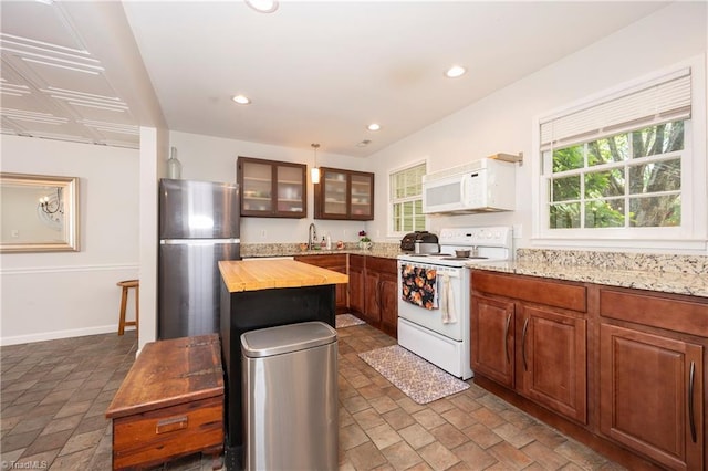 3950 Valley Ct Unit E, Winston-Salem, NC 27106 - kitchen featuring white appliances, wood counters, glass insert cabinets, a kitchen island, and recessed lighting
