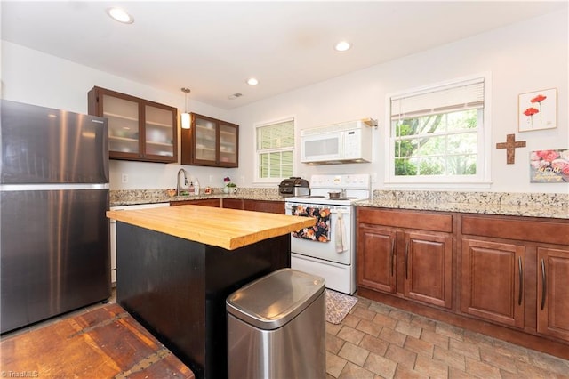 3950 Valley Ct Unit E, Winston-Salem, NC 27106 - kitchen featuring white appliances, butcher block countertops, a sink, glass insert cabinets, and recessed lighting