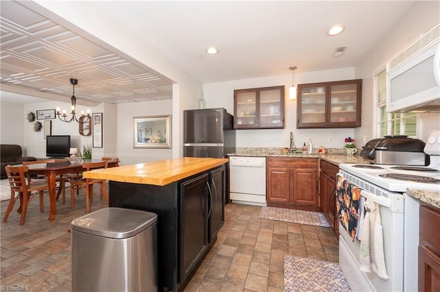 3950 Valley Ct Unit E, Winston-Salem, NC 27106 - kitchen with white appliances, wooden counters, a sink, a chandelier, and glass insert cabinets