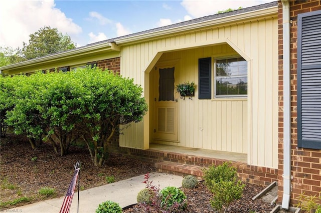 entrance to property featuring brick siding