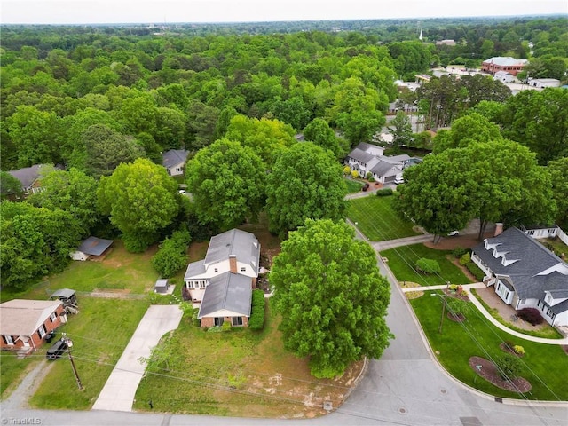 aerial view with a wooded view and a residential view