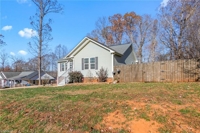 view of side of property with a yard