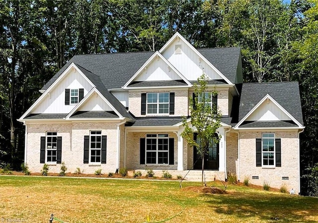 craftsman inspired home with brick siding, a front lawn, board and batten siding, and roof with shingles