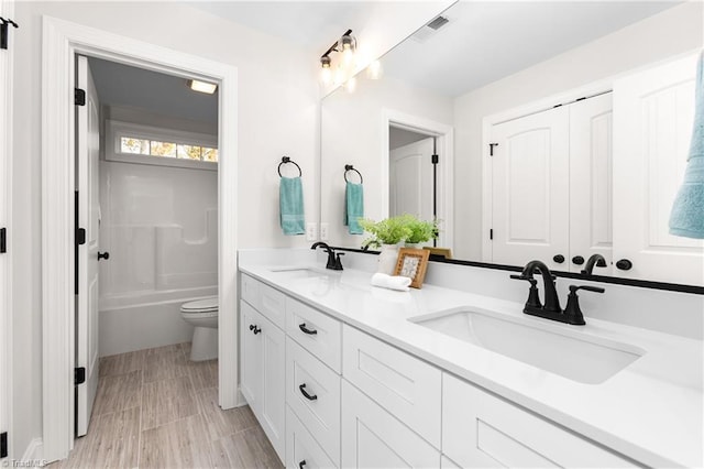 full bathroom with shower / bathtub combination, vanity, and toilet