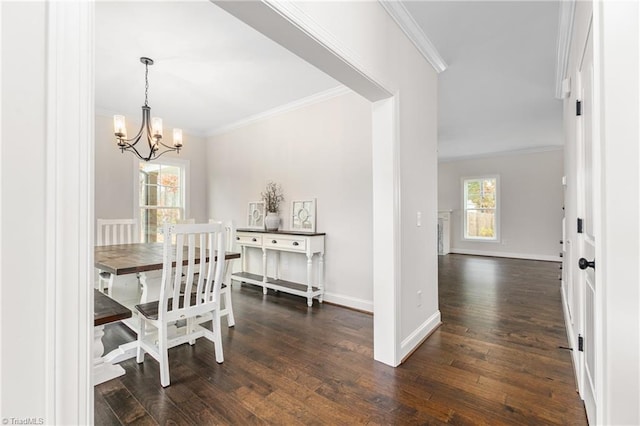 dining space featuring crown molding, dark hardwood / wood-style floors, and a notable chandelier