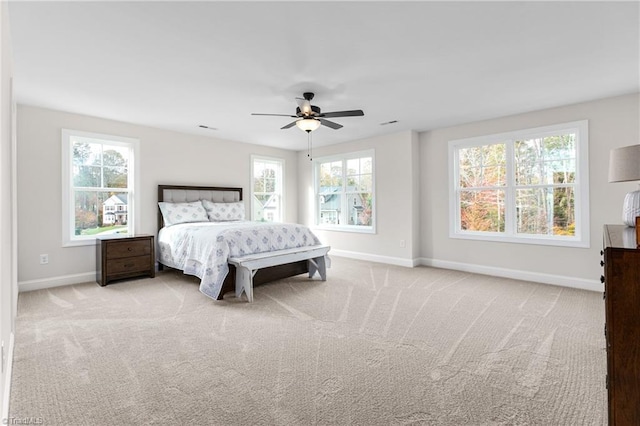 bedroom with light colored carpet and ceiling fan