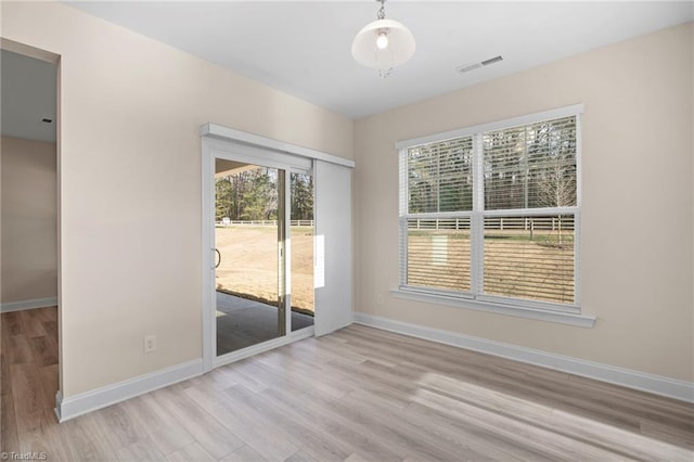 spare room with light hardwood / wood-style flooring