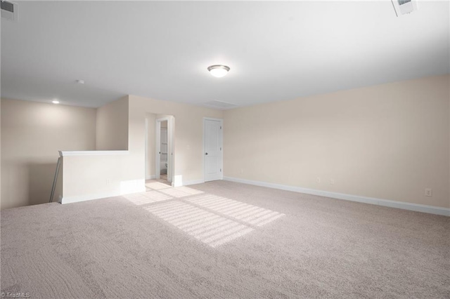 unfurnished room with light colored carpet