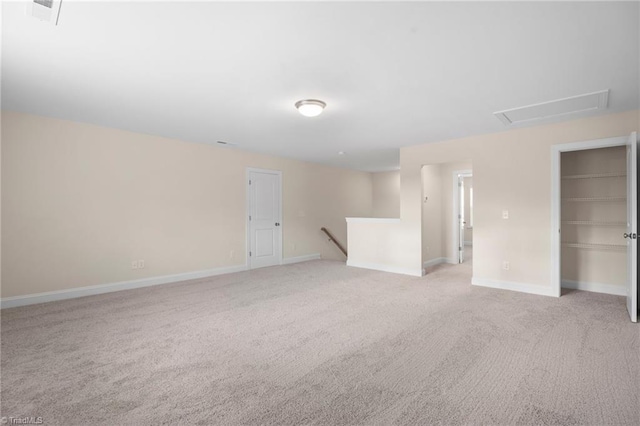 unfurnished room featuring light carpet