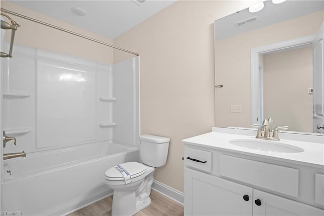 full bathroom with vanity, hardwood / wood-style floors,  shower combination, and toilet