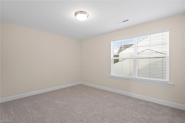 unfurnished room featuring light carpet