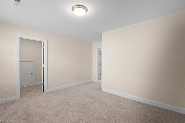 empty room featuring light carpet