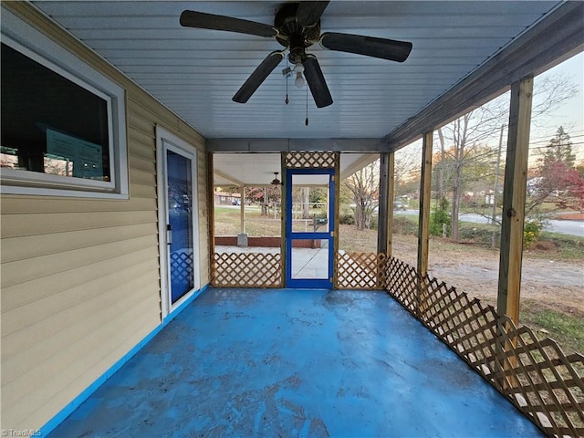 unfurnished sunroom with ceiling fan