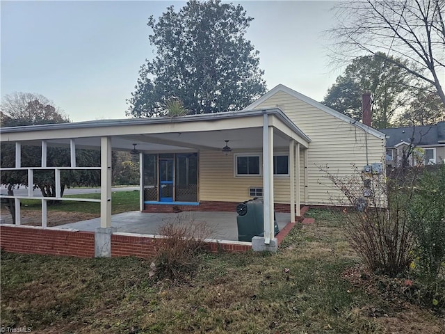 rear view of house featuring a patio and a sunroom